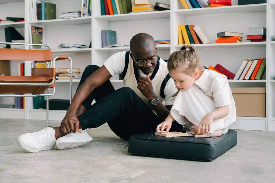 Behavioral health professional supporting a child during a learning activity
